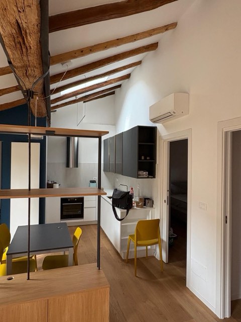 Open space con cucina e travi a vista